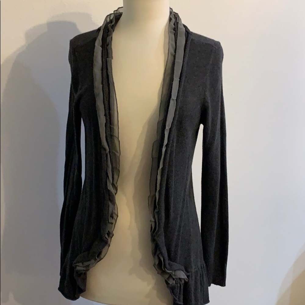 Gray cardigan sweater with light gray ruffle.